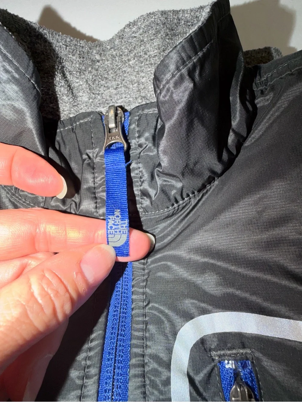 The North Face Kids Black and Gray Jacket with Blue Zip. C13,EMP